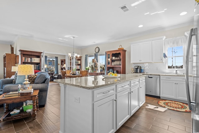 100 Marblehead Dr, Little River, SC 29566 - kitchen with stainless steel dishwasher, a chandelier, white cabinets, open floor plan, and a kitchen island
