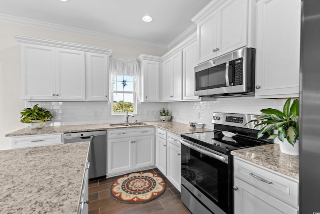 100 Marblehead Dr, Little River, SC 29566 - kitchen featuring stainless steel appliances, ornamental molding, white cabinetry, decorative backsplash, and dark wood-style floors