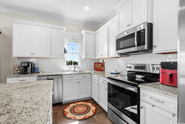 100 Marblehead Dr, Little River, SC 29566 - kitchen featuring stainless steel appliances, a sink, crown molding, white cabinetry, and recessed lighting