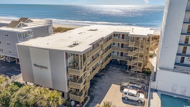 birds eye view of property featuring a water view and a beach view