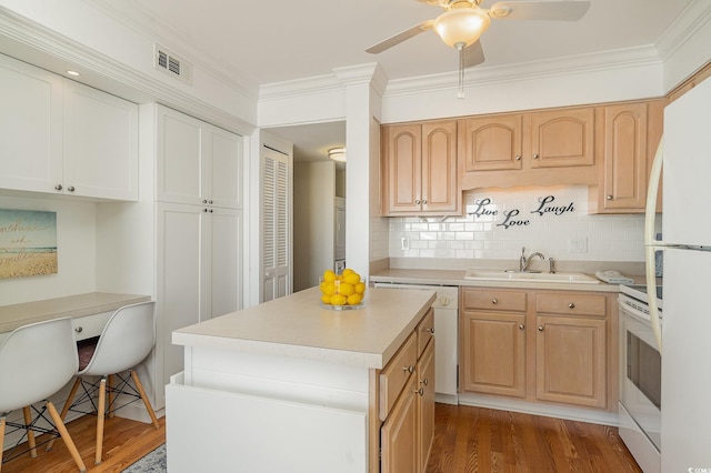 kitchen with white appliances, light countertops, wood finished floors, and a sink