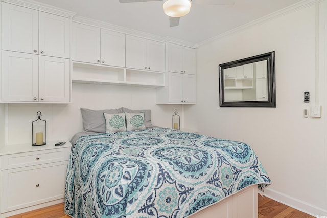 bedroom with ornamental molding, baseboards, ceiling fan, and light wood-type flooring