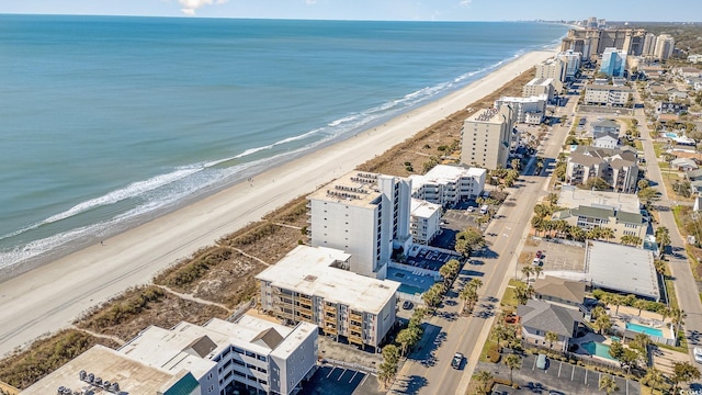 bird's eye view featuring a water view and a beach view