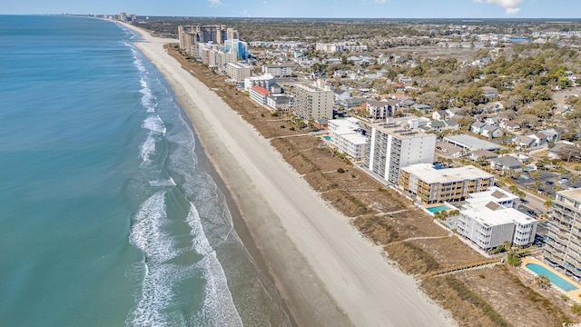 bird's eye view featuring a water view, a beach view, and a city view