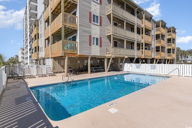 pool featuring a patio and fence