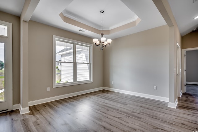 unfurnished room featuring plenty of natural light, wood finished floors, and baseboards