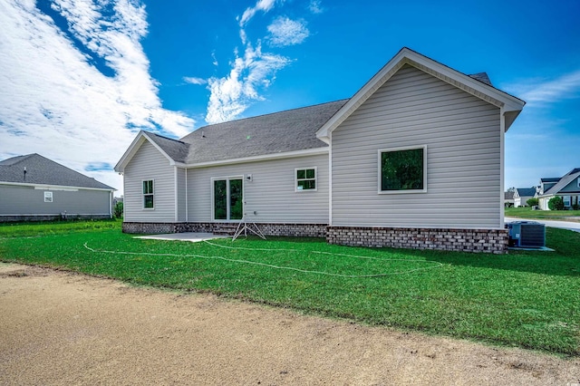 back of property featuring a yard, central AC, a shingled roof, and entry steps