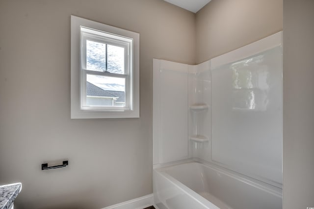 bathroom with baseboards and shower / tub combination