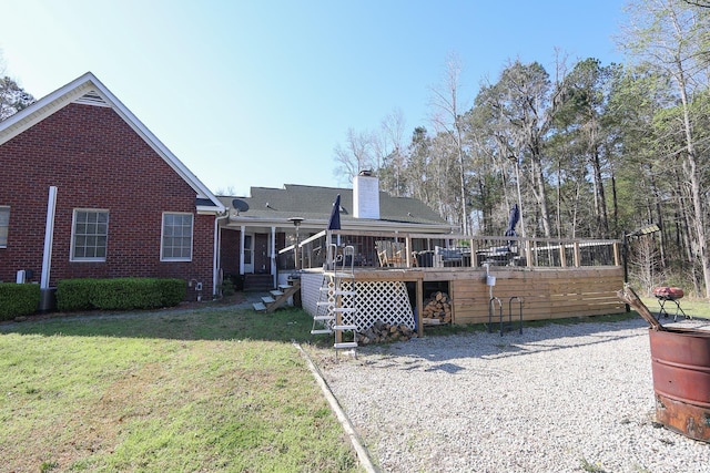3731 Love Ln, Conway, SC 29527 - rear view of house with a yard, a wooden deck, brick siding, and a chimney
