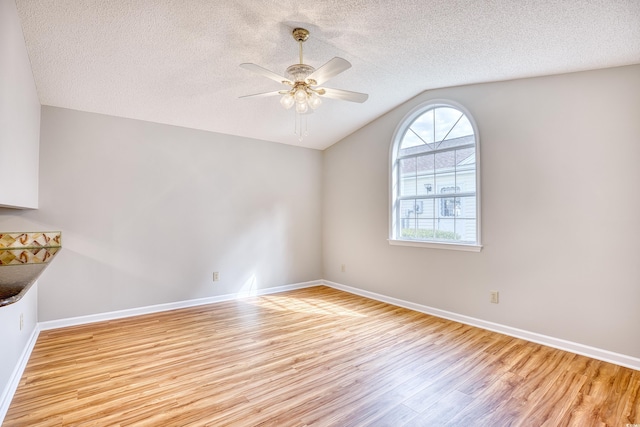 1161 Ganton Way, Myrtle Beach, SC 29588 - empty room featuring light wood-type flooring, vaulted ceiling, a ceiling fan, a textured ceiling, and baseboards