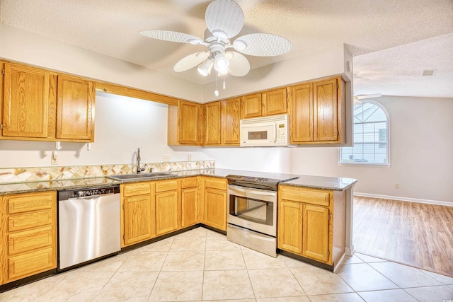 1161 Ganton Way, Myrtle Beach, SC 29588 - kitchen featuring stainless steel appliances, a sink, a ceiling fan, a textured ceiling, and light tile patterned floors