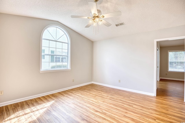 1161 Ganton Way, Myrtle Beach, SC 29588 - unfurnished room with light wood-style floors, lofted ceiling, a textured ceiling, ceiling fan, and baseboards