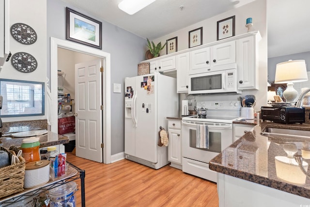 5050 Belleglen Ct Unit 102, Myrtle Beach, SC 29579 - kitchen with a sink, white appliances, dark stone countertops, white cabinets, and light wood-style floors