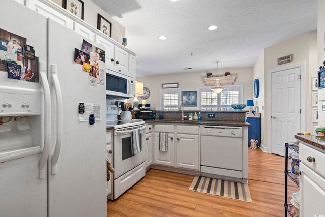 5050 Belleglen Ct Unit 102, Myrtle Beach, SC 29579 - kitchen featuring a sink, a peninsula, white appliances, recessed lighting, and white cabinetry