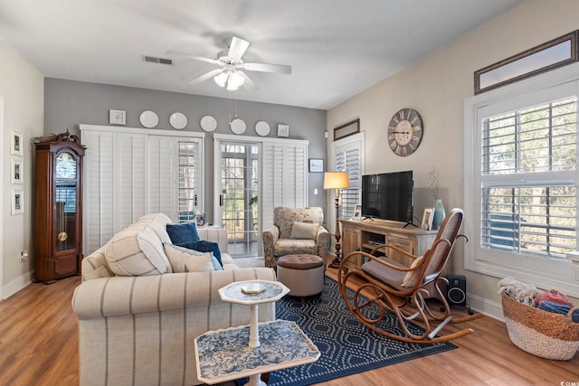 5050 Belleglen Ct Unit 102, Myrtle Beach, SC 29579 - living area with baseboards, visible vents, a ceiling fan, and wood finished floors