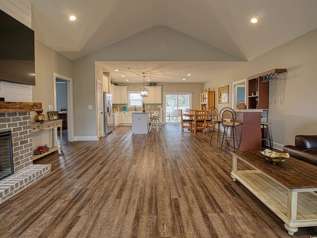 1241 Kenworth Cir, Conway, SC 29526 - living room with a fireplace, dark wood-style floors, lofted ceiling, baseboards, and recessed lighting