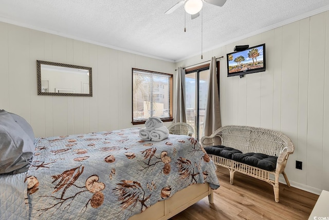 9620 Shore Dr Unit 105, Myrtle Beach, SC 29572 - bedroom with wood finished floors, access to outside, crown molding, ceiling fan, and a textured ceiling