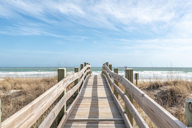 view of property's community with a beach view and a water view