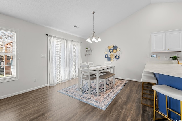 445 Saint Charles Cir, Myrtle Beach, SC 29588 - dining area with vaulted ceiling, dark wood-style flooring, a chandelier, and baseboards