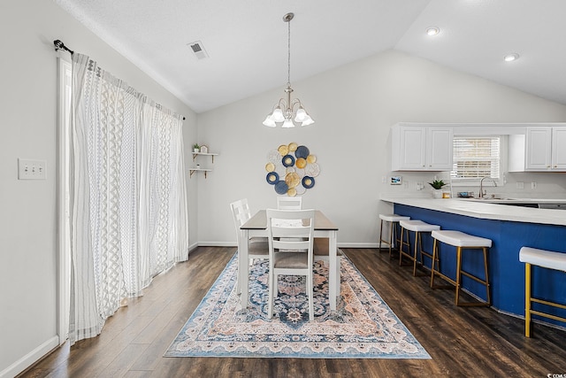 445 Saint Charles Cir, Myrtle Beach, SC 29588 - dining area with lofted ceiling, dark wood finished floors, a chandelier, and baseboards
