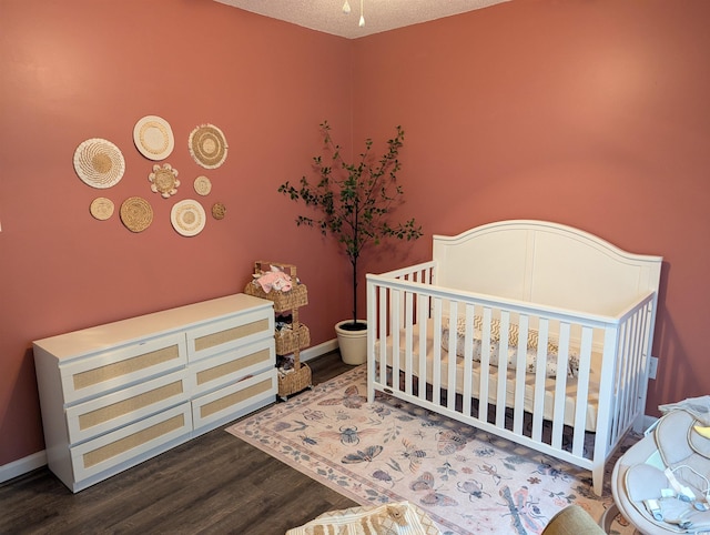 445 Saint Charles Cir, Myrtle Beach, SC 29588 - bedroom with wood finished floors, baseboards, and a crib