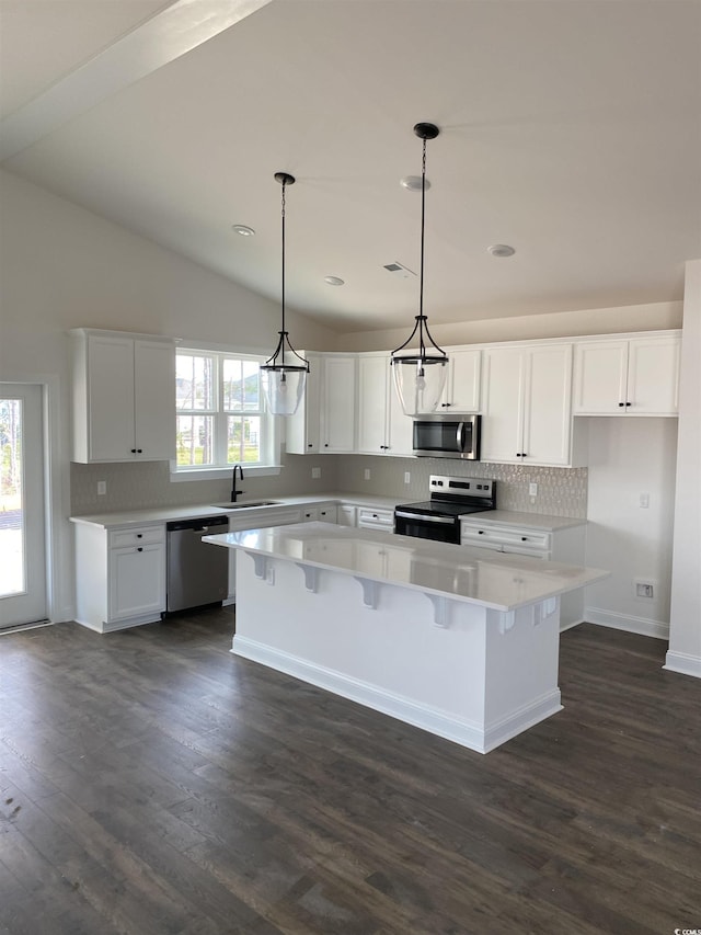 191 Glengrove Ln, Murrells Inlet, SC 29576 - kitchen featuring stainless steel appliances, a kitchen island, tasteful backsplash, white cabinetry, and dark wood finished floors
