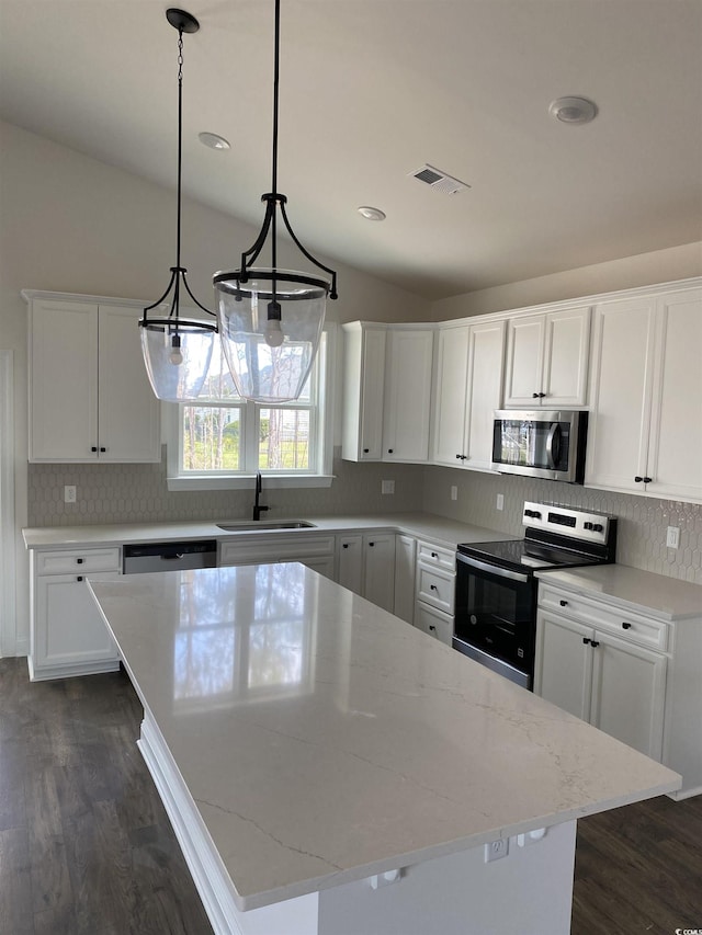 191 Glengrove Ln, Murrells Inlet, SC 29576 - kitchen featuring stainless steel appliances, dark wood finished floors, lofted ceiling, white cabinetry, and light stone counters
