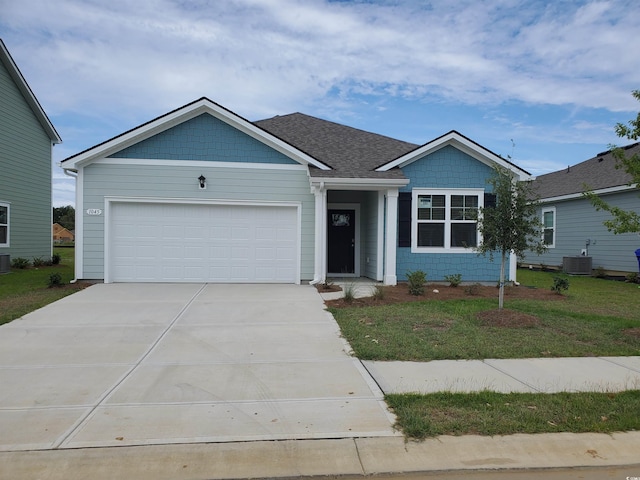 ranch-style home with central air condition unit, an attached garage, driveway, and a front lawn