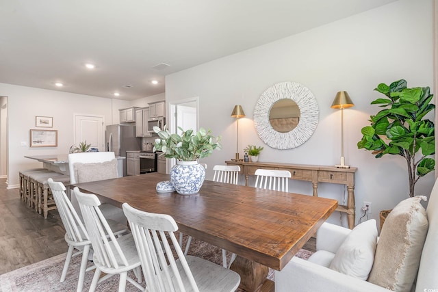 dining room with baseboards, recessed lighting, and wood finished floors