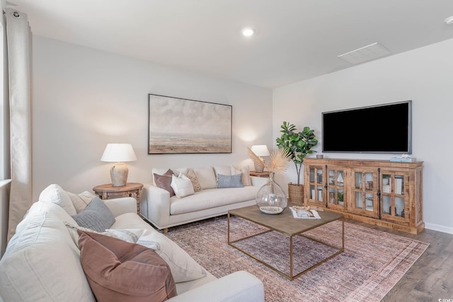 living room with wood finished floors, recessed lighting, and baseboards