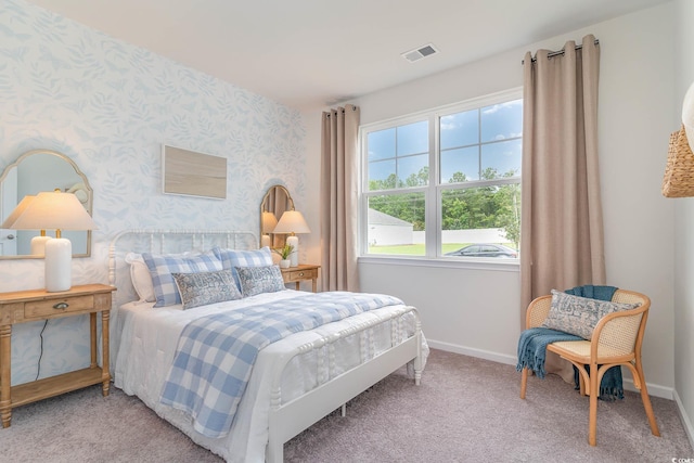 carpeted bedroom with baseboards and wallpapered walls