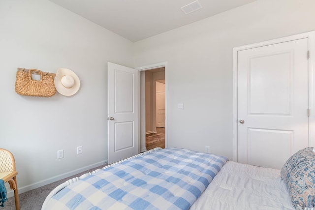 bedroom with baseboards and carpet floors