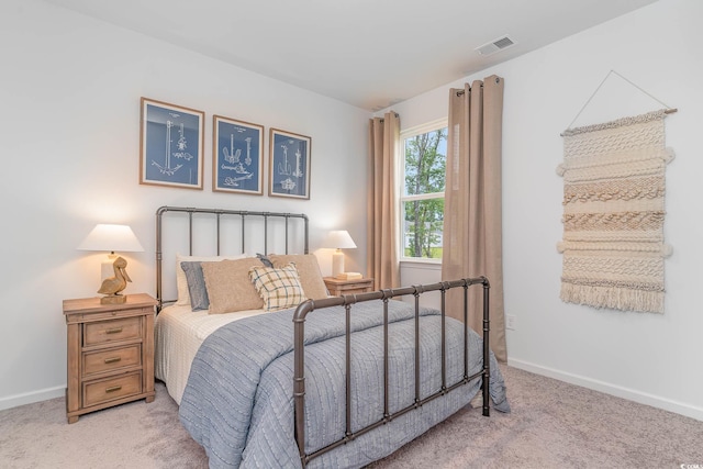 bedroom featuring light colored carpet and baseboards