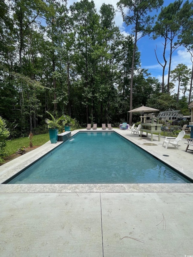 outdoor pool with a patio area