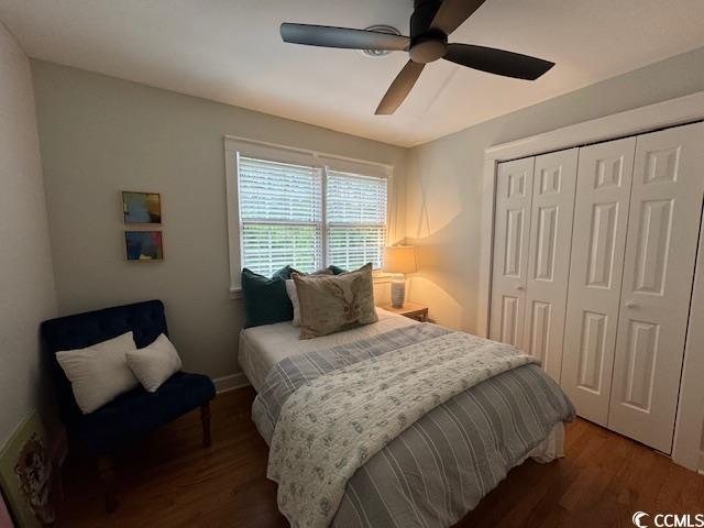 bedroom with wood finished floors, a closet, and ceiling fan