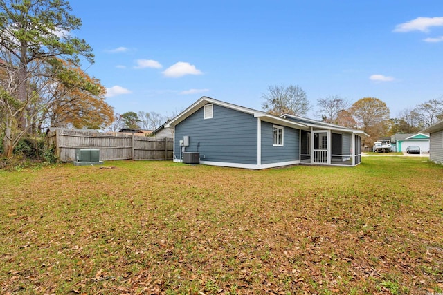 207 Fox Ln, Murrells Inlet, SC 29576 - rear view of house with cooling unit, a sunroom, fence, and a lawn