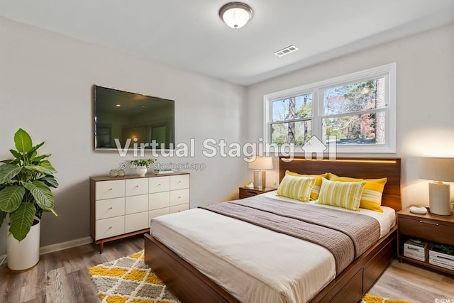 bedroom with wood finished floors and baseboards