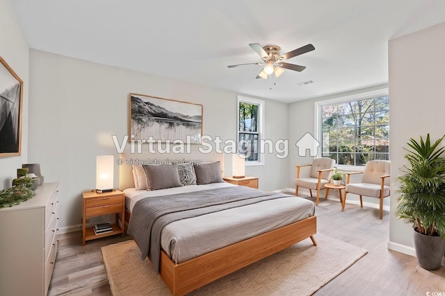 bedroom with light wood finished floors, baseboards, and a ceiling fan
