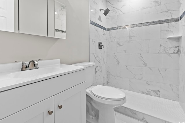 bathroom featuring vanity, toilet, a shower stall, and marble look tile flooring