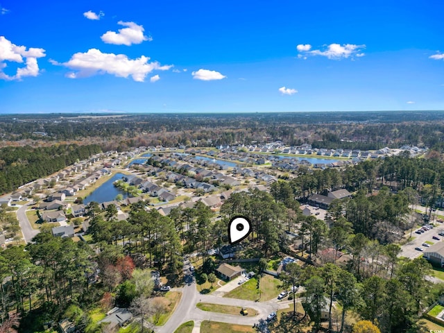 aerial overview of property's location featuring nearby suburban area and a large body of water