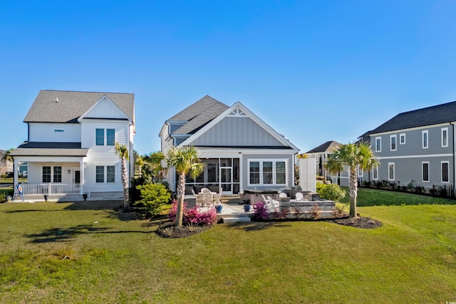 849 Crystal Water Way, Myrtle Beach, SC 29579 - rear view of property featuring board and batten siding, a sunroom, a lawn, and a patio