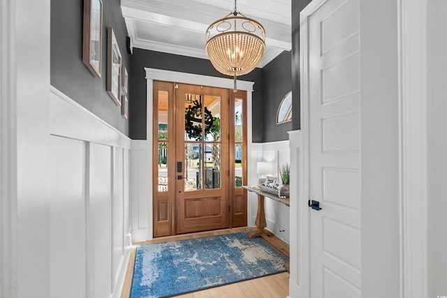 849 Crystal Water Way, Myrtle Beach, SC 29579 - foyer entrance with a decorative wall, a chandelier, a wainscoted wall, wood finished floors, and crown molding