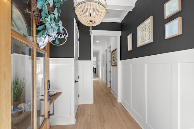 849 Crystal Water Way, Myrtle Beach, SC 29579 - hall featuring a decorative wall, a chandelier, light wood finished floors, wainscoting, and crown molding