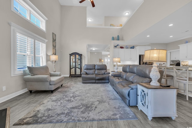 1109 Bonnet Dr, North Myrtle Beach, SC 29582 - living room featuring a towering ceiling, ceiling fan, light wood-type flooring, and recessed lighting