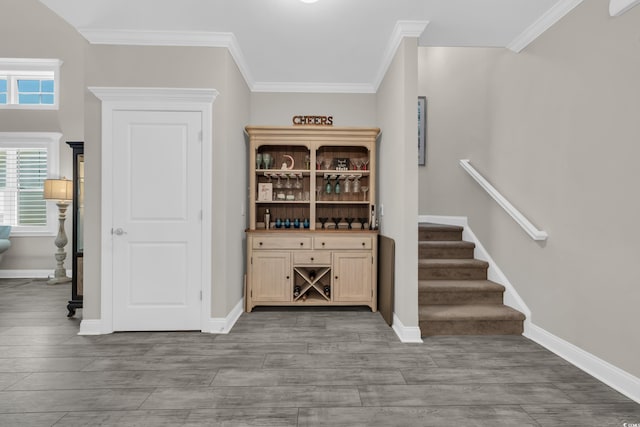 1109 Bonnet Dr, North Myrtle Beach, SC 29582 - bar area featuring wood finished floors, ornamental molding, and healthy amount of natural light