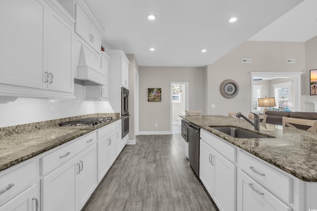 1109 Bonnet Dr, North Myrtle Beach, SC 29582 - kitchen featuring appliances with stainless steel finishes, white cabinetry, healthy amount of natural light, stone countertops, and recessed lighting