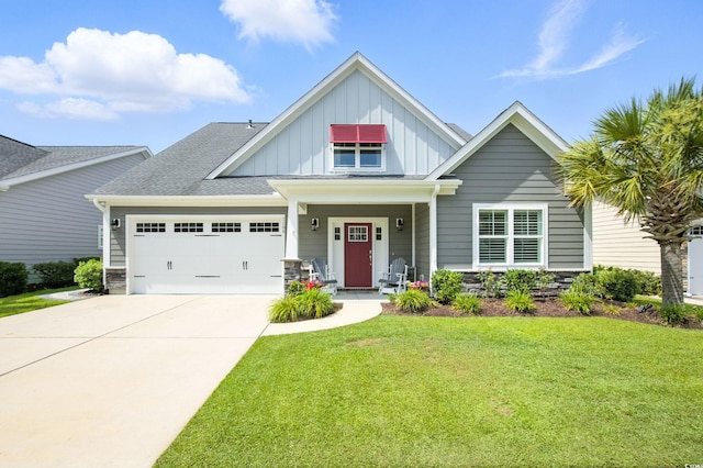 1109 Bonnet Dr, North Myrtle Beach, SC 29582 - craftsman house with board and batten siding, a front yard, an attached garage, driveway, and stone siding