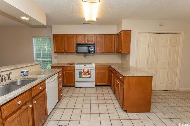 1001 Cardinal Ct, Murrells Inlet, SC 29576 - kitchen with white appliances, a peninsula, brown cabinetry, a sink, and a textured ceiling
