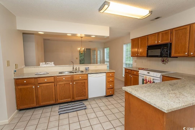 1001 Cardinal Ct, Murrells Inlet, SC 29576 - kitchen with white appliances, a sink, a peninsula, brown cabinetry, and a chandelier