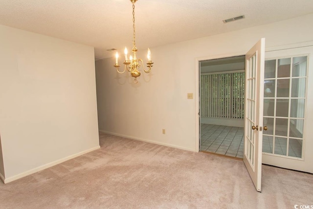 1001 Cardinal Ct, Murrells Inlet, SC 29576 - carpeted spare room with a chandelier, baseboards, a textured ceiling, and french doors